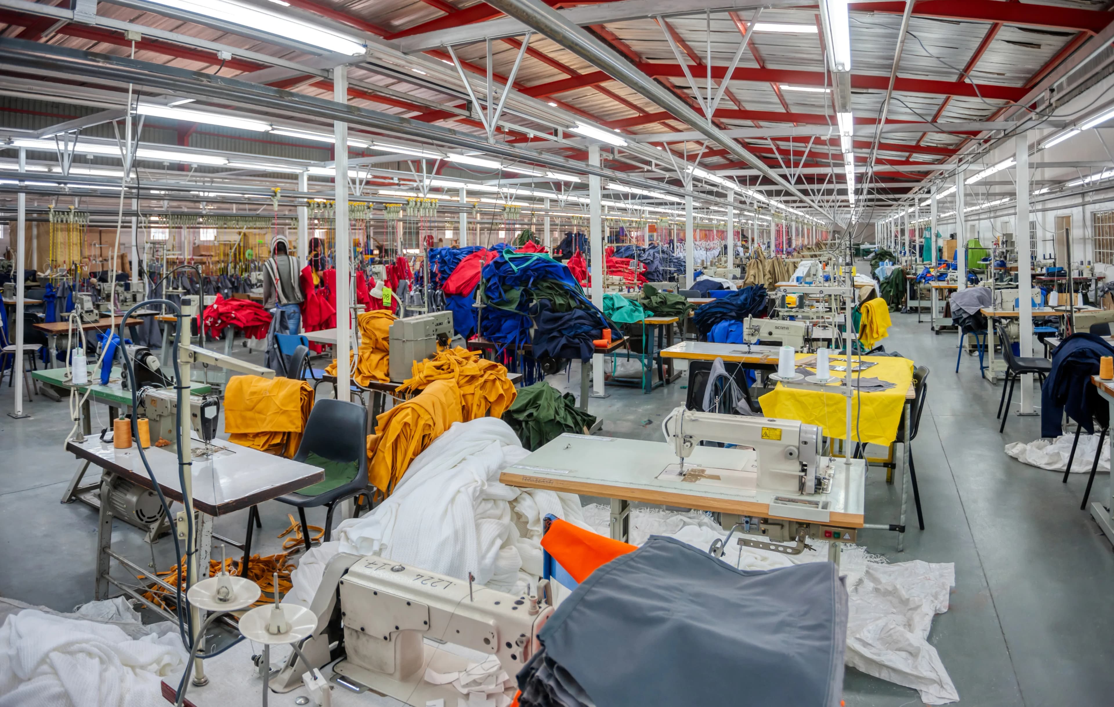 Garment factory with sewing stations and workers