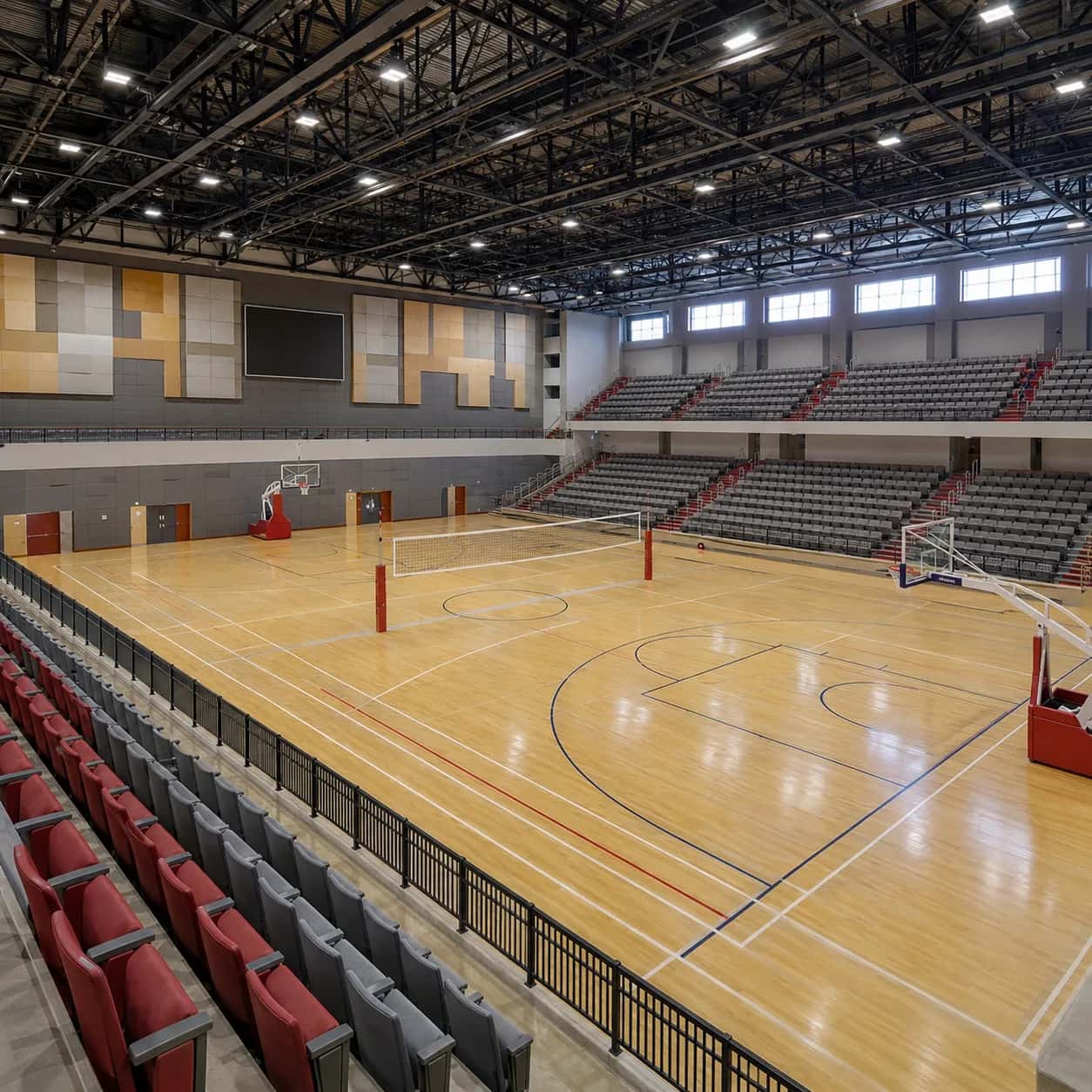 Indoor sports stadium with a wooden multi-purpose court and spectator seating
